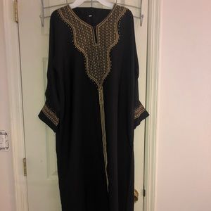 A Black Dress with Gold Accents